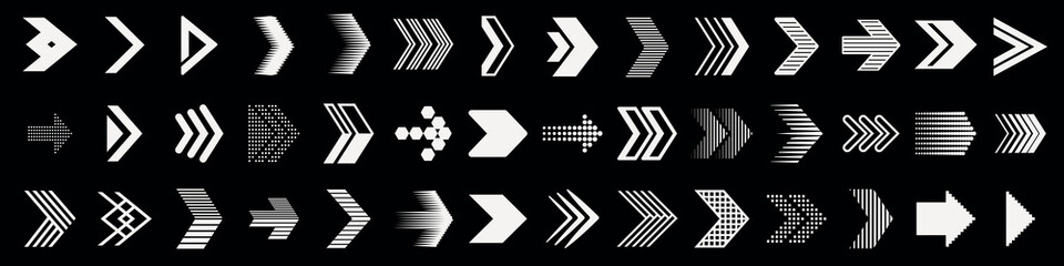 Obraz premium A collection of various white arrow designs on a black background. The arrows vary in style, size, and direction, creating a dynamic and diverse visual pattern. Arrow icon vector set.