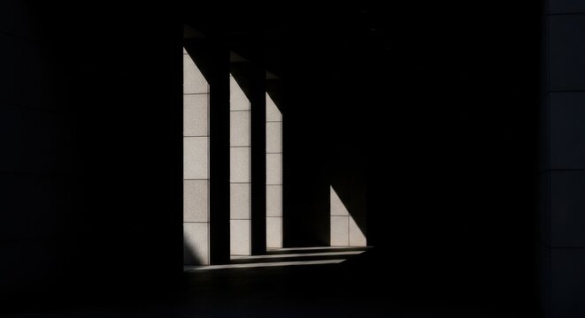 Angular Sunlight Streaks Across Modern Architectural Facade Creating Dramatic Geometric Shadows