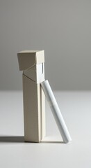 Naklejka premium Unbranded Cardboard Cigarette Pack with Single Cigarette on White Studio Background for Health Awareness Campaigns and Product Mockup