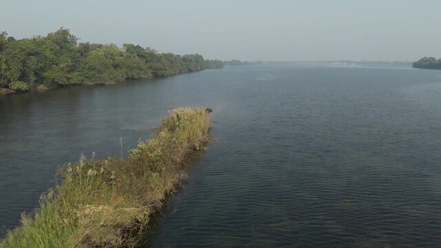 Lake aerial view, serene water landscape, riverside greenery, nature water body stock video.