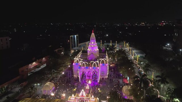 Ram temple night crowd city view, illuminated mandir in busy urban area, city crowd around temple night, festive temple lights urban night stock video.