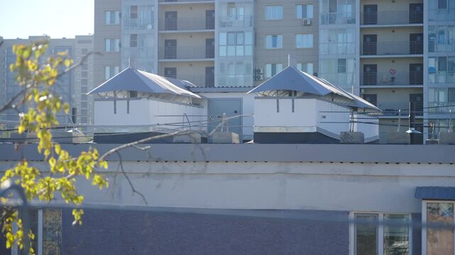 Row of modern homes with spacious balconies and gently sloping roof. Tall apartment houses with glass balconies and strong durable roof