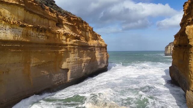 Dramatic aerial view of waves crashing against loch ard gorge cliffs on great ocean road australia.