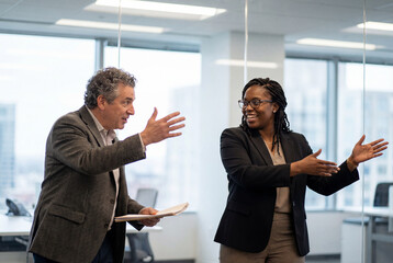 Fototapeta premium Diverse business colleagues gesturing during an animated office discussion