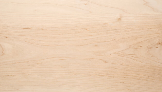Close-up view of a smooth, light-colored wooden surface showcasing natural wood grain patterns, perfect for backgrounds and textures in design.