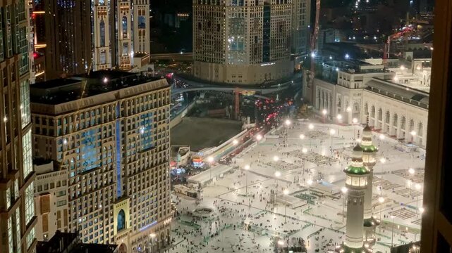 Timelapse view from above showing Umrah pilgrims walking across the courtyard of Masjid al-Haram in Makkah, capturing the busy yet spiritual atmosphere