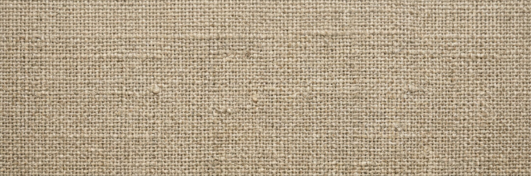 Close up texture of natural beige burlap fabric, woven jute with a rough surface pattern