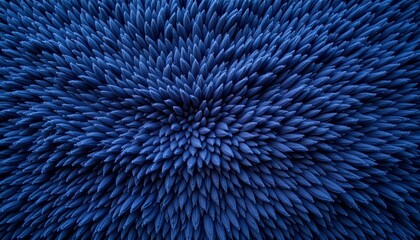 Fototapeta premium A textured surface with a circular pattern that resembles spikes in hues of blue and gray. The texture appears to be made up of small, uniform elements that create the spiky effect