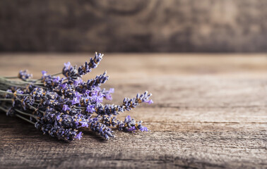 Fototapeta premium Dried lavender bouquet on a rustic wooden surface with soft lighting