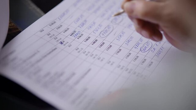 Hand Writing Numbers In Financial Document Paper. Making Corrections In Spreadsheet Ledger. Financial Management And Bookkeeping 