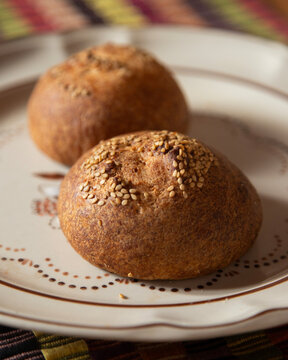 Pan de yema chiapas mexico traditional bread with sesame seeds on a wooden board
