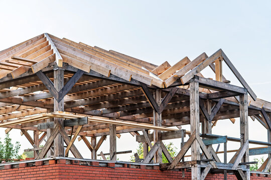 Weathered wooden beams above brick, dusk tones and softened shadows reveal signs of decay and preservation planning, structural survey atmosphere focusing