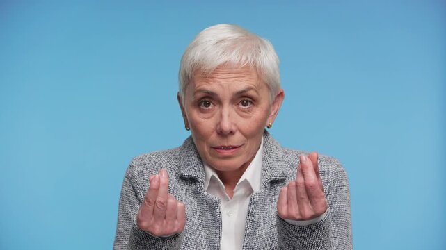 Senior woman asking for money on blue background
