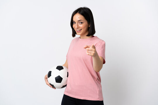 Young caucasian woman isolated on white background with soccer ball and pointing to the front