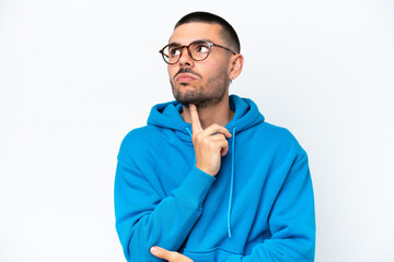 Young caucasian man isolated on white background With glasses and looking up