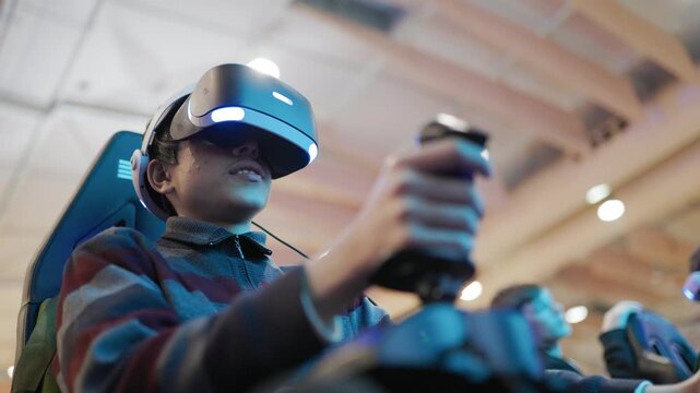 Young boy playing a virtual reality flight simulator game