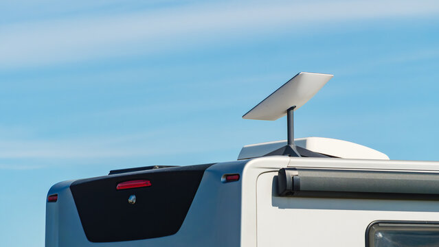 Awning on side of caravan and Starlink terminal on roof