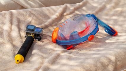 Bright snorkel and mask rest on soft towel © I