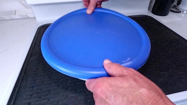 Meat on the bone is marinating in a bowl, mixing with spices and salt