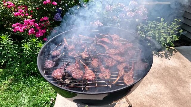 Lamb ribs are grilled over hot coals, the meat is turned with a spatula