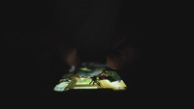 Man holding mobile phone while finding information, swiping on the screen