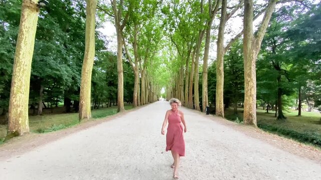  Affectionate Blonde Woman Blowing a Kiss in a Tree-Lined Avenue
