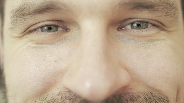 Happy male looking at camera. Cropped, close up. Eye care, vision concept