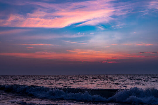 Dramatic red sunset over the ocean at Marari Beach, Alappuzha, Kerala, India
