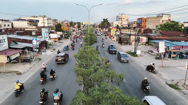 Indonesian City Street Traffic at Sunset with Busy Commuters and Tropical Golden Hour