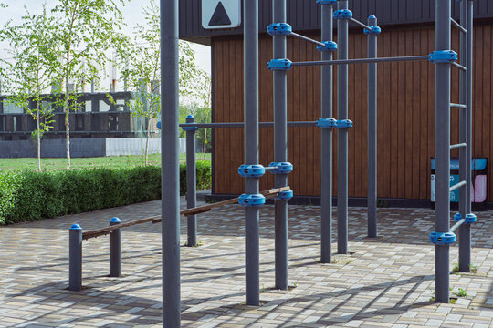 Empty outdoor street workout park with metal pull-up bars