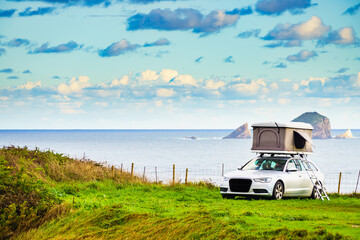 Car with roof top tent camp on sea shore © anetlanda