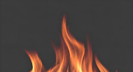 Fototapeta premium Close-up of vibrant orange flames dancing against a dark, moody background, evoking warmth and energy.