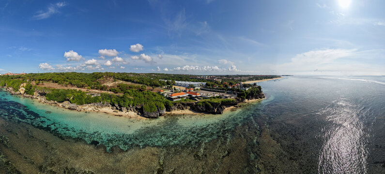 Aerial Panoramic View of Geger Beach and Nusa Dua Coastline with Luxury Resorts and Turquoise Coral Reefs in Bali, Indonesia