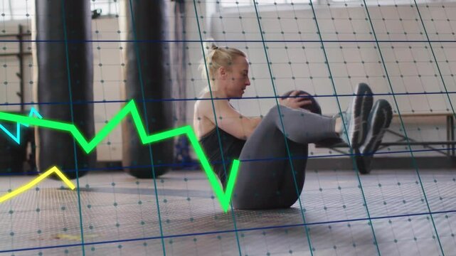 Woman doing seated medball twists from boat hold in gym, grid and traces tracking core engagement
