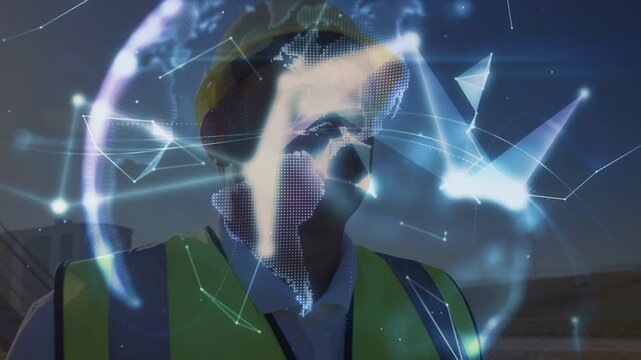 Site worker holding hand up as network overlay appears forming hologram globe above hand for review