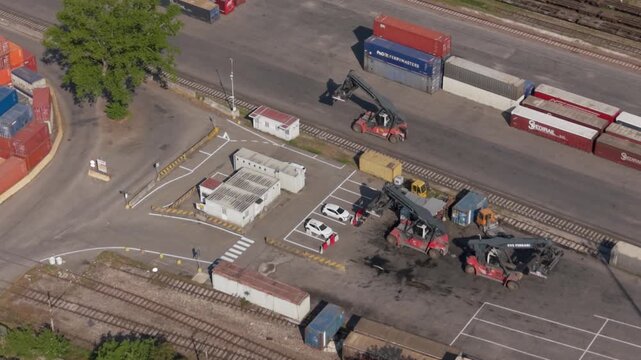 Shipping Port Aerial View: An aerial perspective reveals a bustling shipping port, with cargo containers stacked high and cranes in motion.