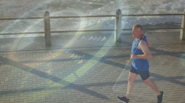Senior male jogger entering frame jogging past bollards as lens flare overlaying runner for fitness
