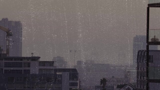 Vertical video: Fixed camera holding while haze moving and dust overlaying midrise roofs for design