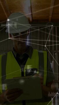 Vertical video: Site inspector wearing hardhat and vest tapping tablet, activating HUD for safety