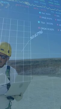 Vertical video: Tech opening laptop monitoring data showing 3D grid around him with rising percent