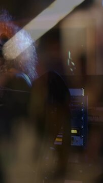 Vertical video: Female singer turning into frame, singing for recording, headphones and reflections