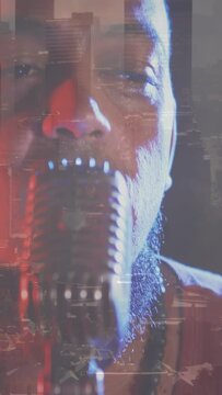 Vertical video: Camera zooming out, singer near mic, recording music with red-blue skyline glitch
