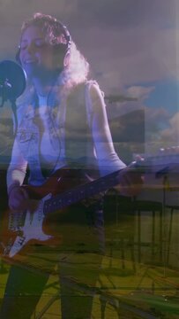 Vertical video: Woman guitarist starting strumming singing into mic recording landscape overlay
