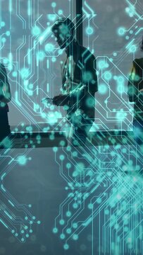 Vertical video: Man walking along window, tilting device, sharing tech data under cyan AR overlay