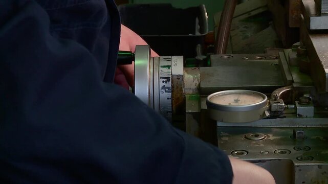 a turner works on a lathe at a metalworking plant
