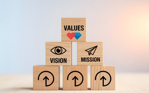 Wooden blocks stacked in a pyramid showing values vision and mission with for business growth
