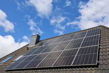 Fototapeta premium Solar panels generating clean energy on house roof