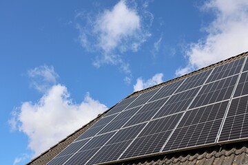 Fototapeta premium Solar panels on a roof harnessing sunlight for sustainable energy