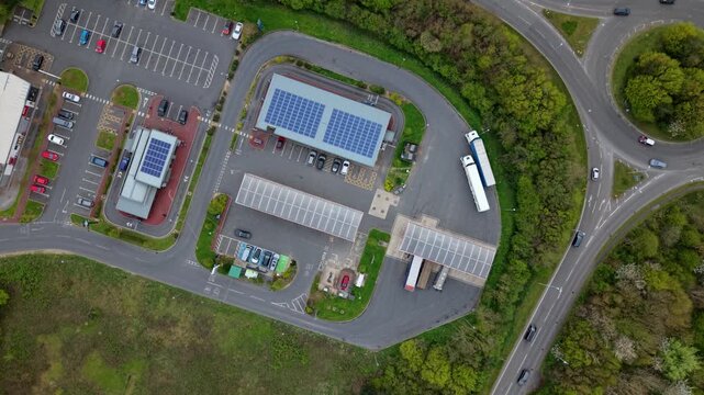 Drone shot of a commercial petrol station forecourt and road infrastructure during high fuel demand in the UK