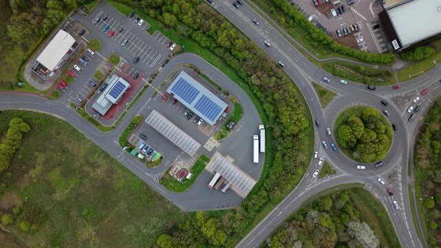 Drone shot of a commercial petrol station forecourt and road infrastructure during high fuel demand in the UK
